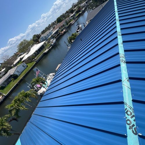 Closeup of Blue Metal Roof with view of the Tampa Bay water in the background